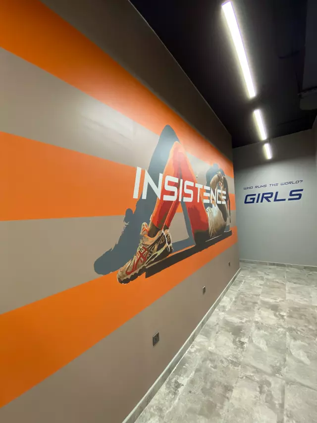 Insistence mural in a gym corridor